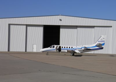aviation hangar with a private airplane in front