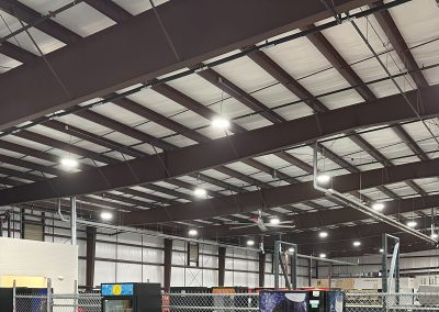 Empty warehouse with metal shelving unit (photo showcases the frames overhead)