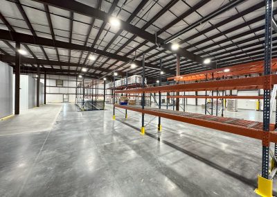 Empty warehouse with metal shelving units