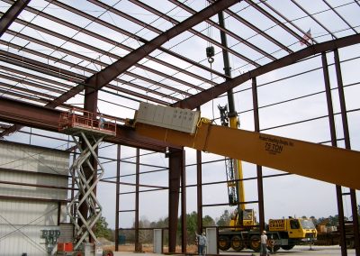 A manufacturing facility under construction with metal beams showing